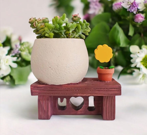 Plant Pot with Pot Person sitting on Bench with Sunflower
